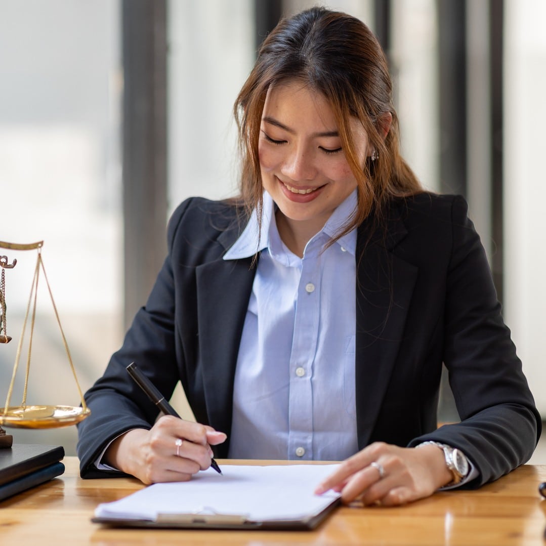 Lawyer female writing on desk